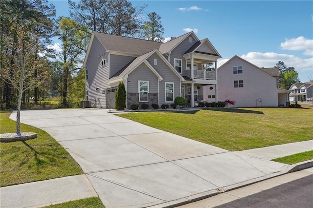 2860 Windsor Knoll Dr, Dacula, GA 30019 - craftsman house featuring a balcony, concrete driveway, a front yard, and stone siding