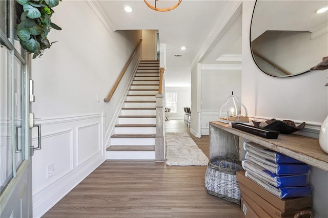 2860 Windsor Knoll Dr, Dacula, GA 30019 - entryway with ornamental molding, stairway, a decorative wall, wood finished floors, and wainscoting