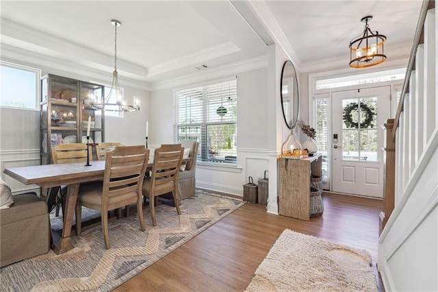 2860 Windsor Knoll Dr, Dacula, GA 30019 - dining area featuring a chandelier, wood finished floors, healthy amount of natural light, a decorative wall, and a wainscoted wall