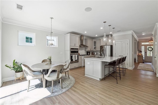 2860 Windsor Knoll Dr, Dacula, GA 30019 - kitchen featuring appliances with stainless steel finishes, wall chimney exhaust hood, ornamental molding, light countertops, and recessed lighting