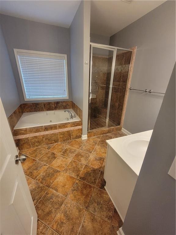 bathroom featuring independent shower and bath and vanity