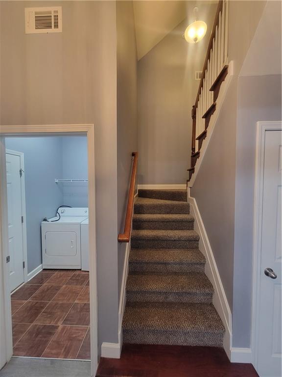 stairs featuring washer and dryer