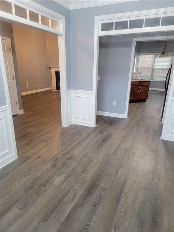 interior space with crown molding and dark hardwood / wood-style flooring