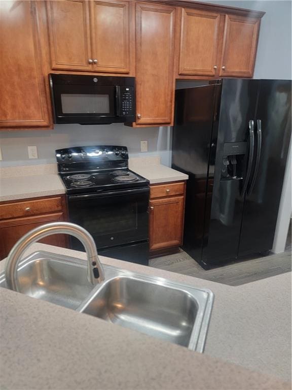 kitchen with sink and black appliances