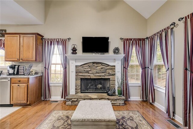 living room with high vaulted ceiling, ceiling fan with notable chandelier, and hardwood / wood-style floors