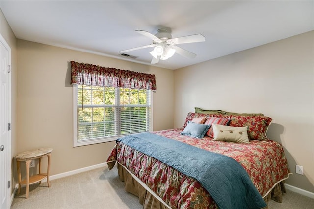 bedroom with ceiling fan and light carpet