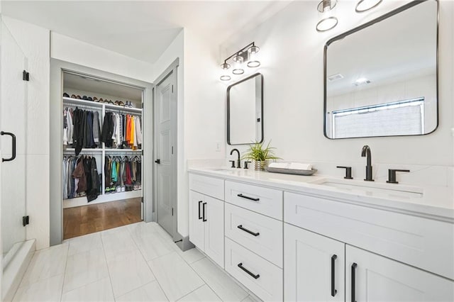 2357 Lynn Iris Dr, Decatur, GA 30032 - bathroom with double vanity, a sink, a walk in closet, and an enclosed shower