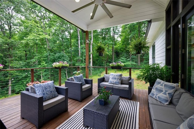 wooden deck featuring outdoor lounge area and ceiling fan