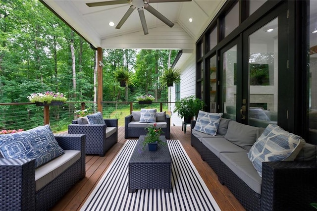 sunroom with ceiling fan and vaulted ceiling