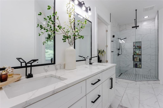 bathroom with a sink, marble finish floor, and a stall shower