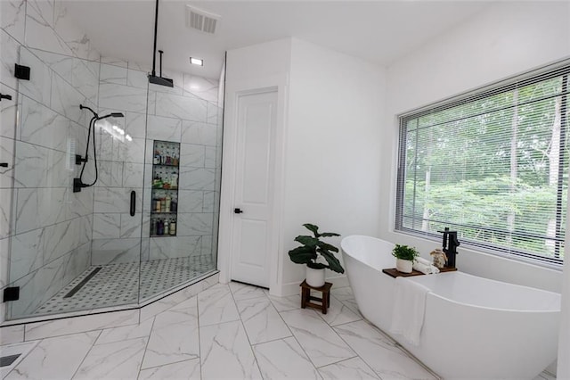 full bath with a freestanding tub, visible vents, marble finish floor, and a stall shower