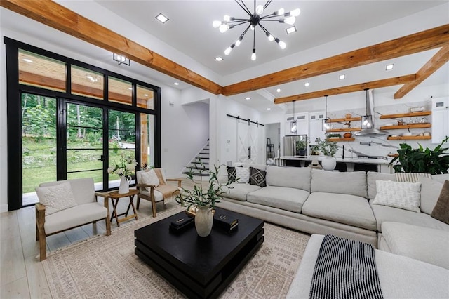 living room featuring beamed ceiling, a notable chandelier, recessed lighting, a barn door, and light wood-style floors