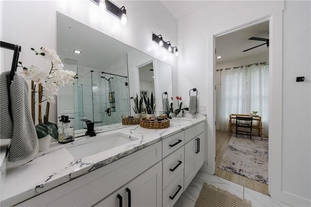 bathroom with vanity, marble finish floor, and a shower stall