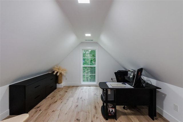 office featuring visible vents, baseboards, wood finished floors, and vaulted ceiling