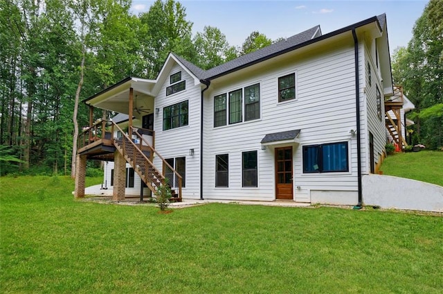 back of property featuring stairway, ceiling fan, a patio, and a yard