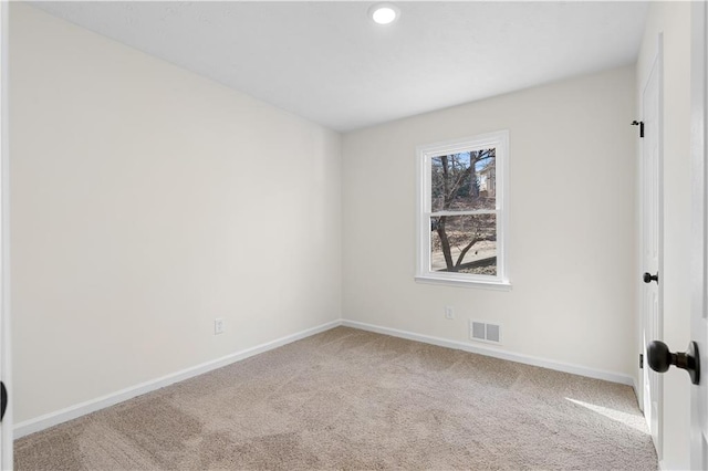 spare room featuring recessed lighting, carpet, visible vents, and baseboards