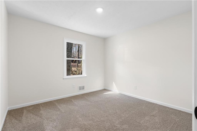 carpeted spare room featuring recessed lighting, visible vents, and baseboards