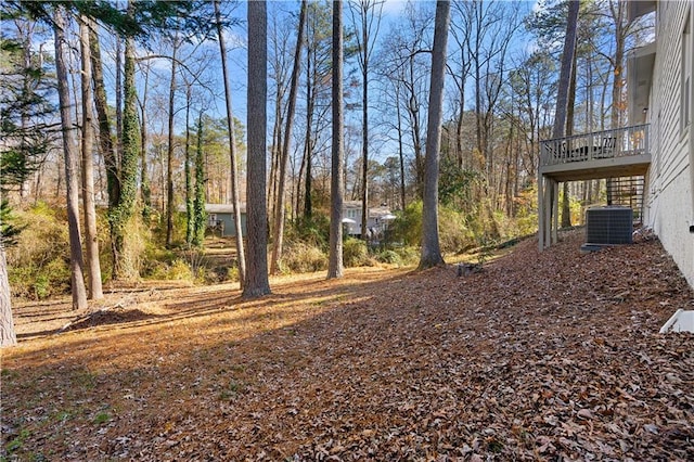 view of yard featuring stairway and central AC unit