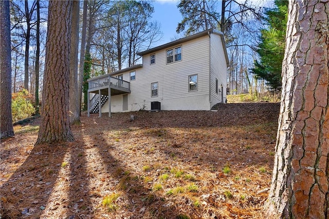back of house featuring stairs, cooling unit, and a deck