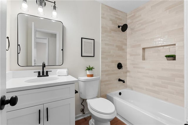 bathroom featuring bathtub / shower combination, vanity, and toilet