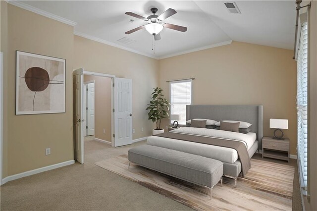 bedroom with ornamental molding, vaulted ceiling, ceiling fan, and light colored carpet