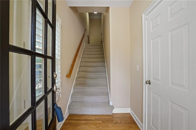 stairs featuring wood-type flooring