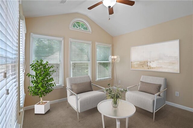 living area with carpet floors, lofted ceiling, and ceiling fan