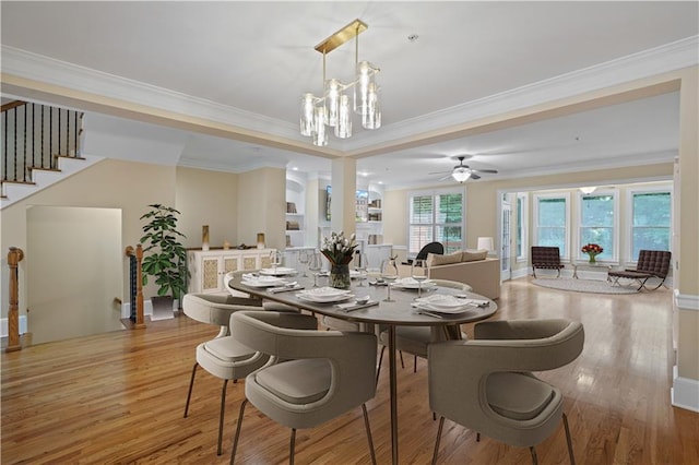 dining room featuring light wood-type flooring, crown molding, and ceiling fan