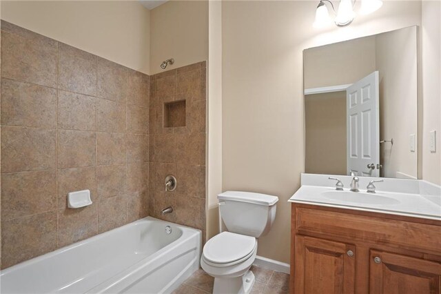 full bathroom with tiled shower / bath, vanity, tile patterned flooring, and toilet