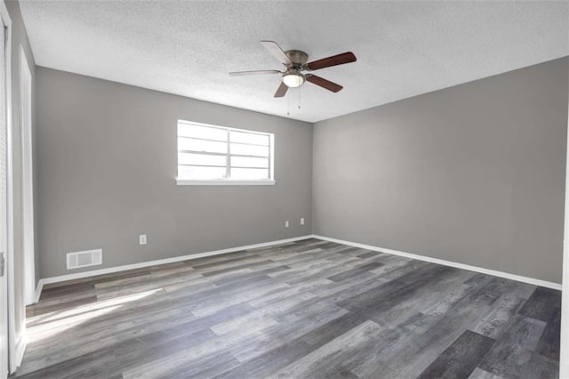 unfurnished room featuring a textured ceiling, ceiling fan, and dark hardwood / wood-style floors