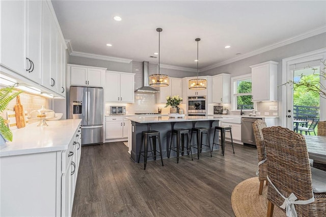 1865 Henley Way, Alpharetta, GA 30009 - kitchen featuring wall chimney range hood, appliances with stainless steel finishes, a kitchen island, backsplash, and white cabinetry