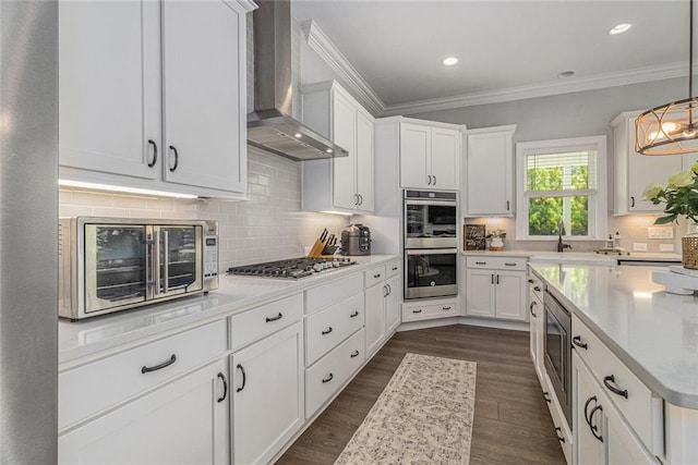 1865 Henley Way, Alpharetta, GA 30009 - kitchen featuring wall chimney exhaust hood, appliances with stainless steel finishes, white cabinets, a sink, and crown molding