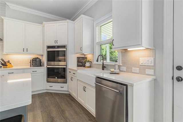 1865 Henley Way, Alpharetta, GA 30009 - kitchen featuring appliances with stainless steel finishes, crown molding, a sink, light countertops, and backsplash