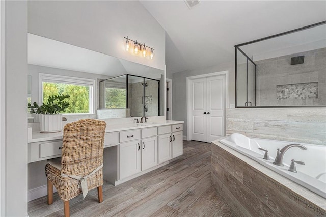 1865 Henley Way, Alpharetta, GA 30009 - full bathroom featuring vaulted ceiling, a stall shower, a garden tub, vanity, and wood finished floors