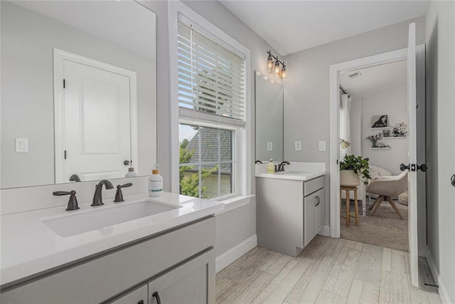 1865 Henley Way, Alpharetta, GA 30009 - bathroom with two vanities, baseboards, and wood finished floors