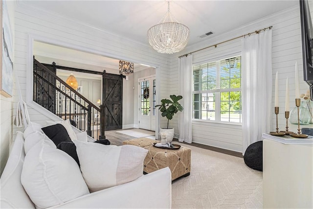 1865 Henley Way, Alpharetta, GA 30009 - living area featuring a barn door, a chandelier, crown molding, baseboards, and stairs
