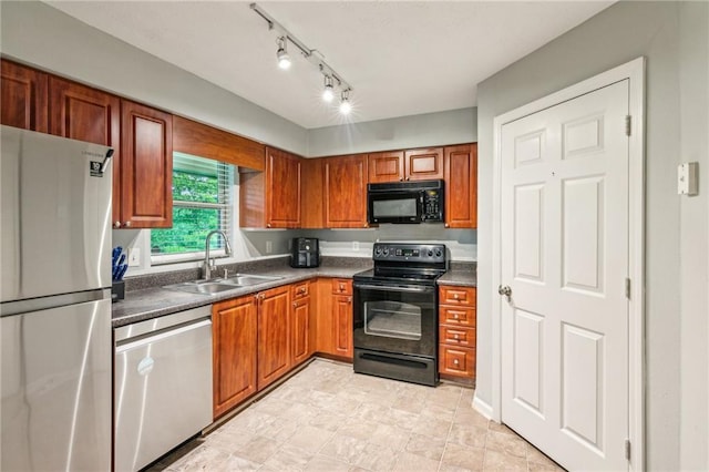 kitchen featuring black appliances, a sink, dark countertops, and brown cabinetry