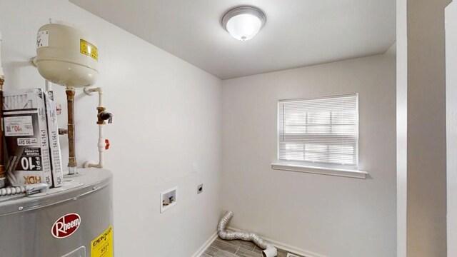 clothes washing area featuring water heater, laundry area, electric dryer hookup, and baseboards