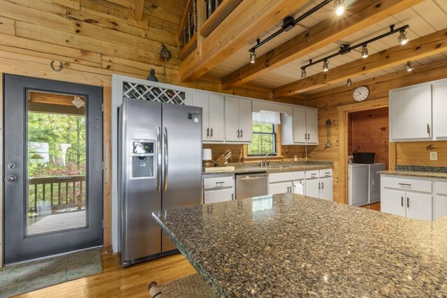852 Black Bear Den Rd, Clayton, GA 30525 - dining room featuring wooden walls, light wood-style flooring, a chandelier, and a wealth of natural light