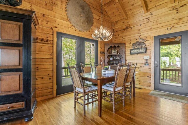 852 Black Bear Den Rd, Clayton, GA 30525 - living area featuring stairs, beam ceiling, wood finished floors, wooden walls, and high vaulted ceiling