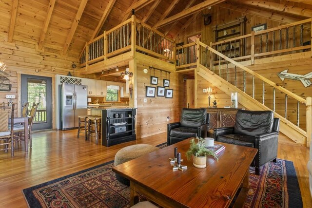 852 Black Bear Den Rd, Clayton, GA 30525 - living room featuring wooden walls, high vaulted ceiling, plenty of natural light, wood finished floors, and wood ceiling