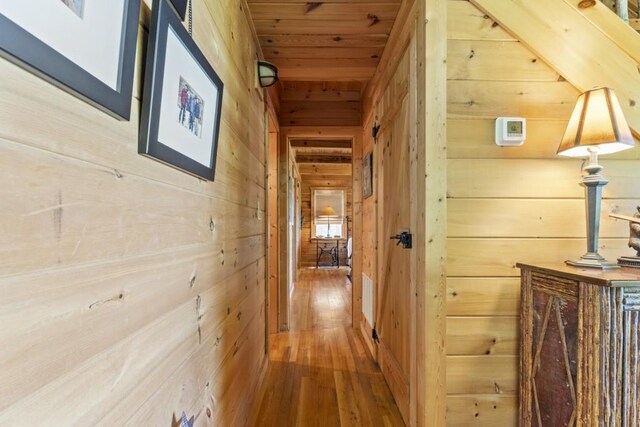 852 Black Bear Den Rd, Clayton, GA 30525 - bedroom with beamed ceiling, wood walls, and wood finished floors