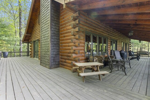 852 Black Bear Den Rd, Clayton, GA 30525 - back of property with stone siding, a deck, a chimney, a patio area, and an attached garage