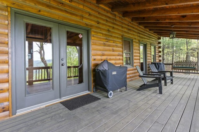 852 Black Bear Den Rd, Clayton, GA 30525 - deck with outdoor dining space and an outdoor fire pit