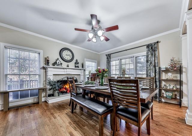 kitchen featuring a peninsula, a ceiling fan, appliances with stainless steel finishes, wood finished floors, and a sink