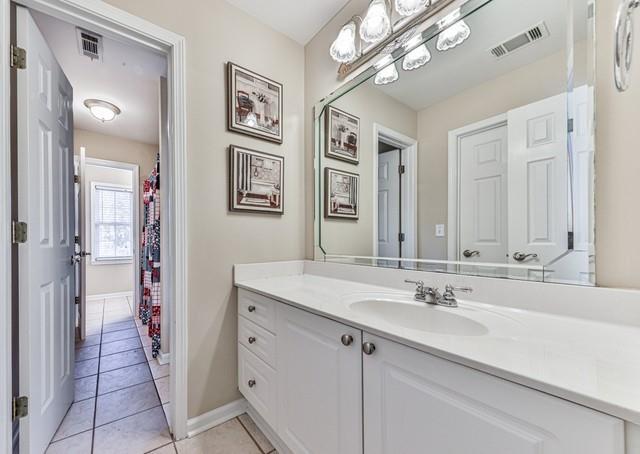 bathroom with a shower with shower curtain and toilet