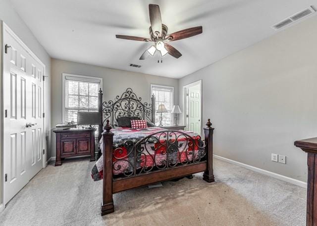 bedroom featuring light carpet, ceiling fan, baseboards, and visible vents