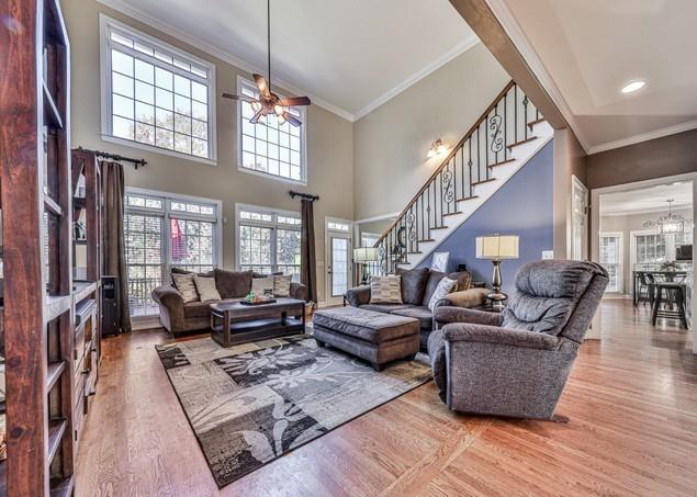 entrance foyer with decorative columns, light wood finished floors, and ornamental molding