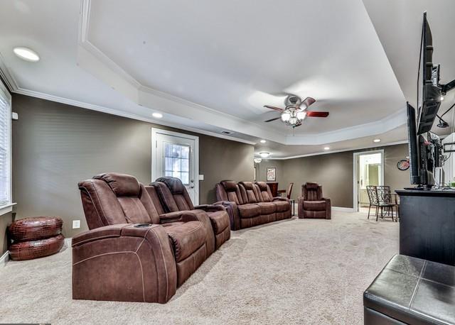 carpeted bedroom featuring visible vents, ceiling fan, and vaulted ceiling