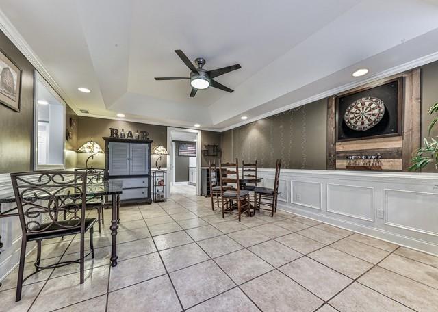 game room featuring visible vents, a tray ceiling, billiards, wainscoting, and light tile patterned flooring